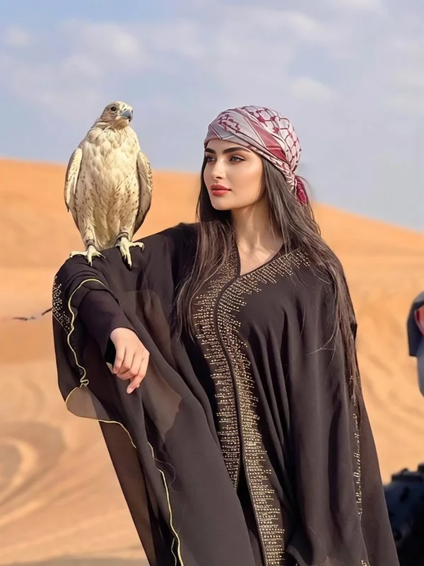 Illustrative adult portrait: Desert travel portrait with a falcon